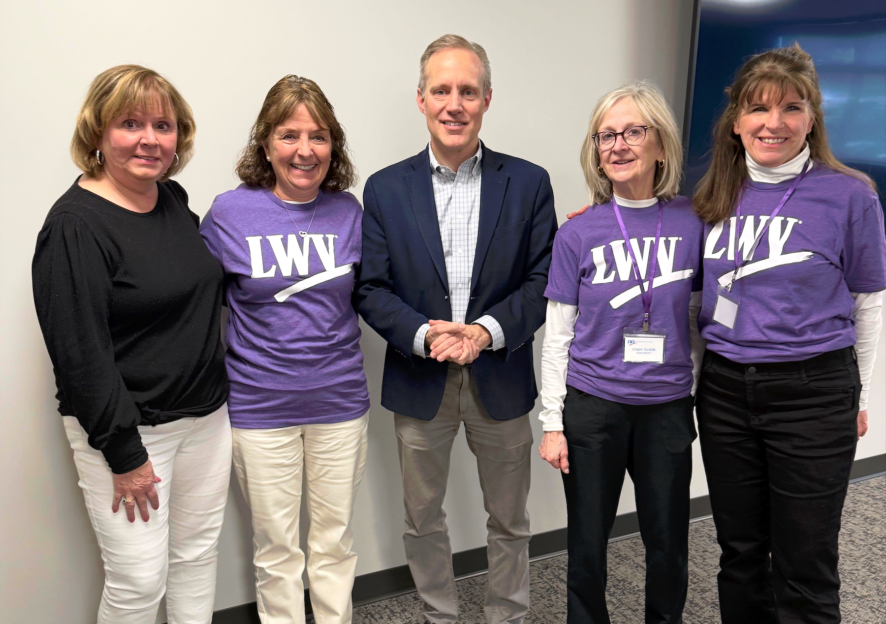 4 women, 3 with LWV T-shirts on and Sec of State Simon